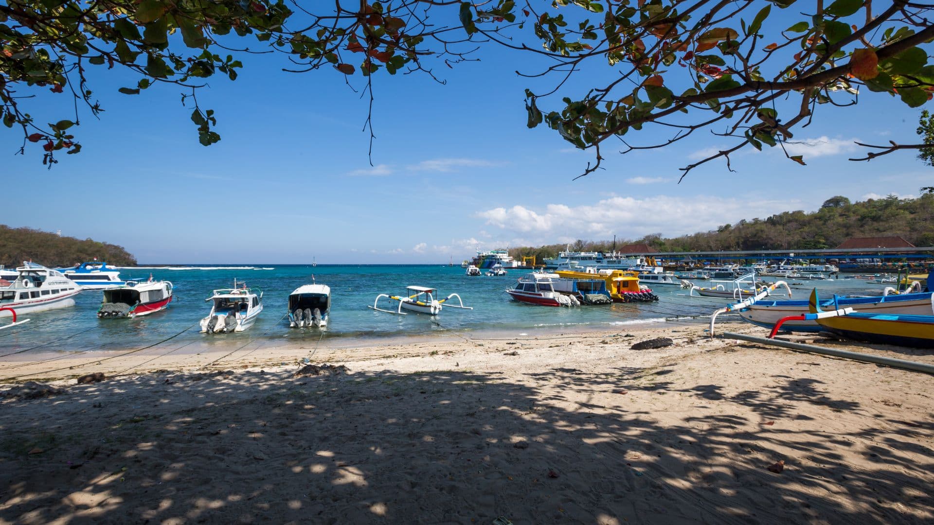 Fast boats and jukung anchored at Padang Bai Harbour beach, Bali